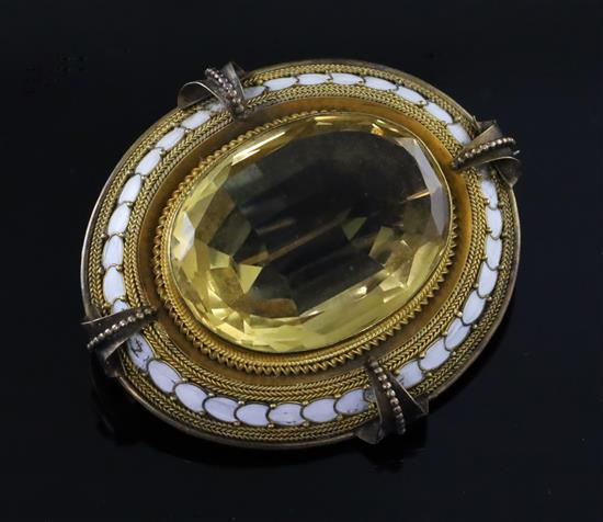 A Victorian gold, white enamel and citrine set oval brooch, 50mm.